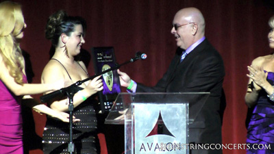 Chelsea Vigil presenting Stevie Hawkins songwriter award.